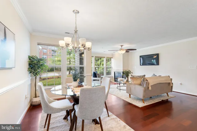 a living room with furniture a chandelier and a table