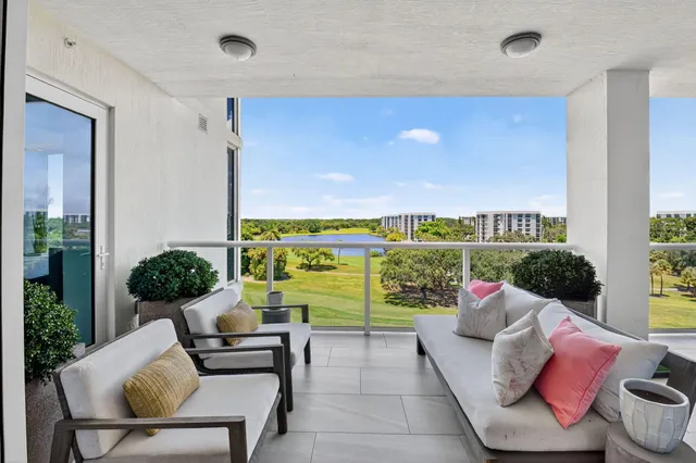 a view of a chairs and table in the balcony