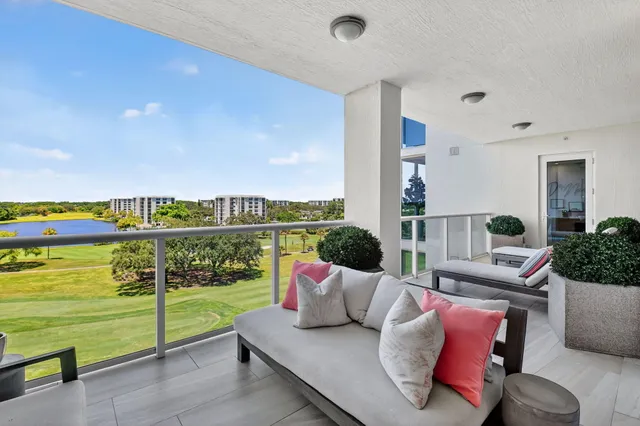 a balcony with furniture and garden view
