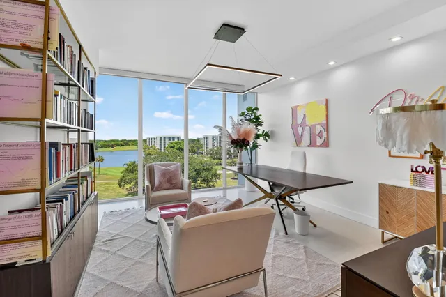 a living room with furniture and a floor to ceiling window