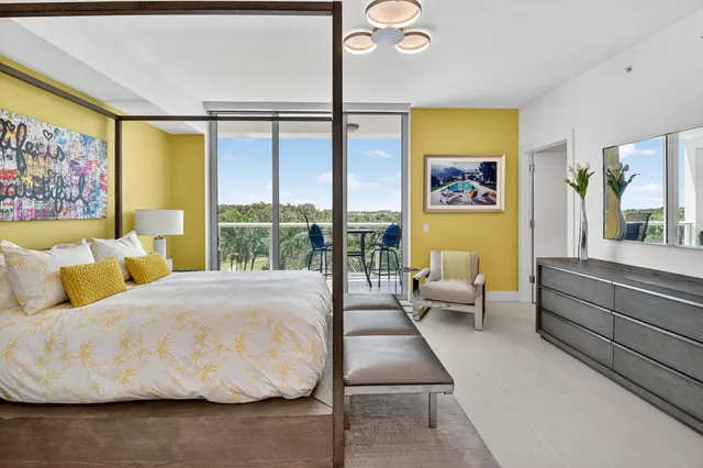 a bedroom with a bed and glass window