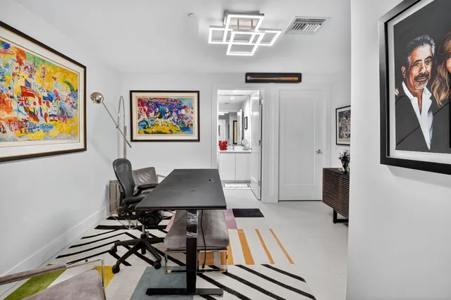 a view of a workspace with furniture and wooden floor