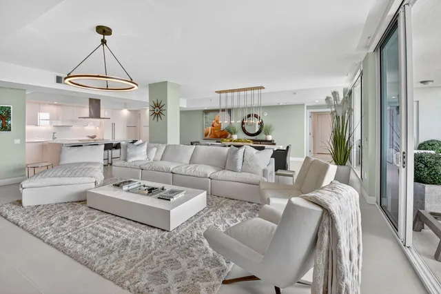 a living room with furniture a rug and a chandelier