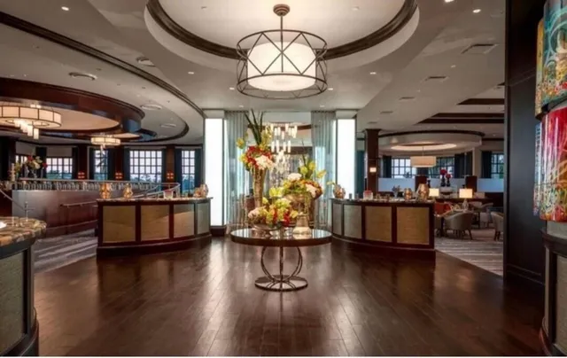 a room with lots of chairs and chandelier