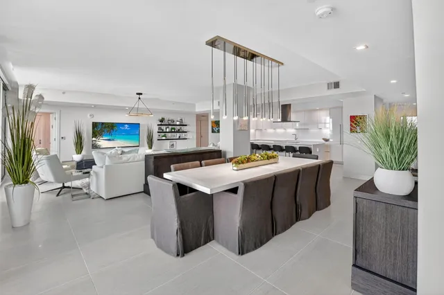 a kitchen with stainless steel appliances kitchen island granite countertop a stove a sink dishwasher and a refrigerator