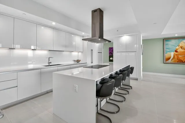 a kitchen with cabinets and chairs