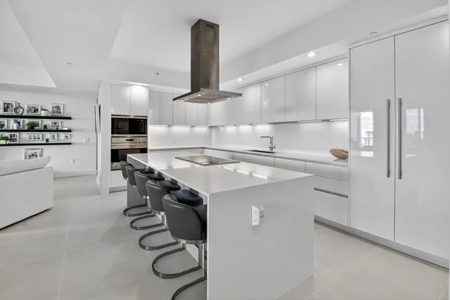 a kitchen with a sink stainless steel appliances and cabinets