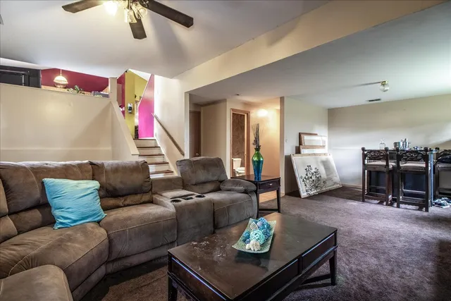 a living room with furniture and a dining table