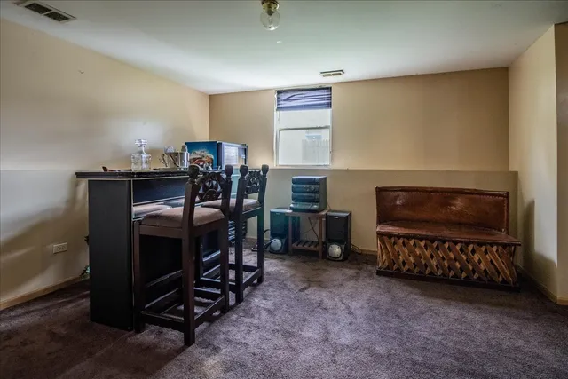 a view of a workspace with furniture and a fireplace