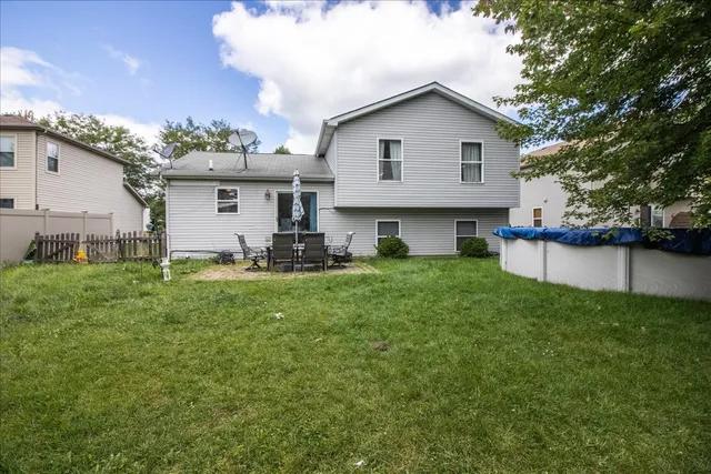 a front view of house with a garden and trees