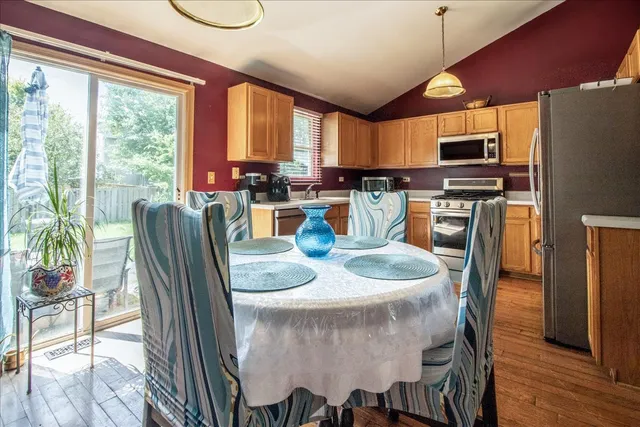 a dining room with furniture a window and wooden floor