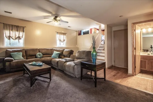 a living room with furniture and a chandelier