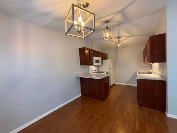 a view of a kitchen with a sink and wooden floor