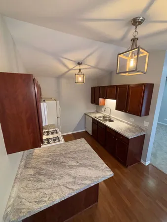 a living room with stainless steel appliances kitchen island granite countertop furniture a rug and a chandelier