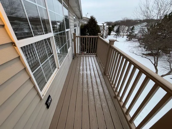 a view of balcony with wooden floor and stairs