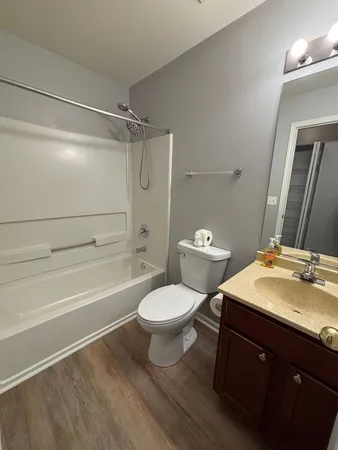a bathroom with a sink toilet vanity and shower