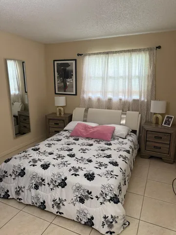 a bedroom with a bed and dresser