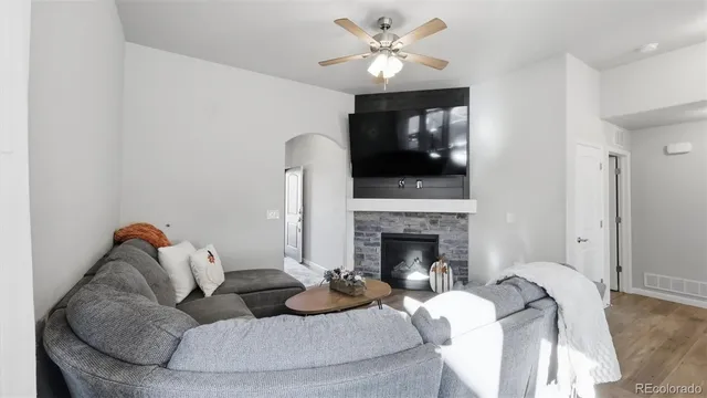 a living room with furniture and a fireplace