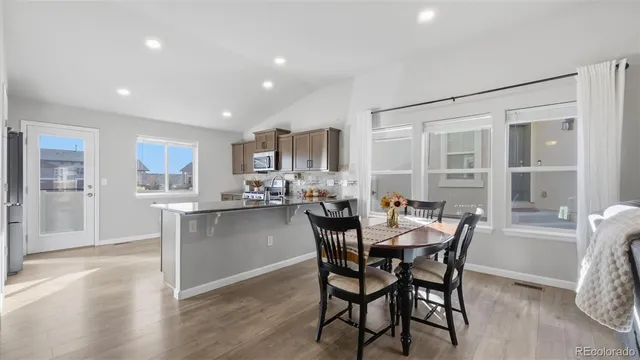 a view of a dining room with furniture and wooden floor