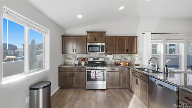 a kitchen with stainless steel appliances granite countertop a stove and a sink