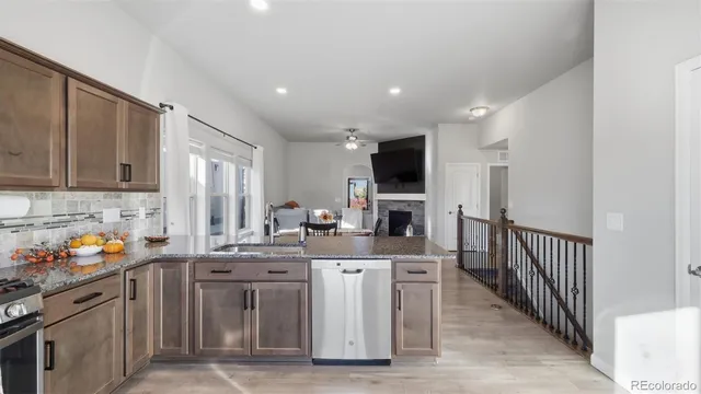 a kitchen with stainless steel appliances kitchen island granite countertop a sink stove and cabinets