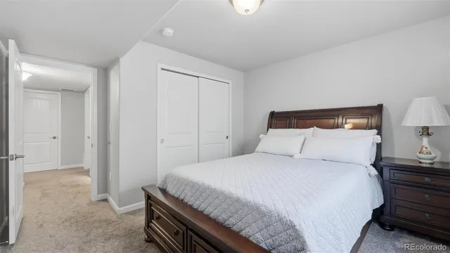 a bedroom with a bed and a night stand