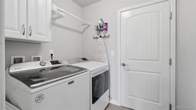 a utility room with sink dryer and washer