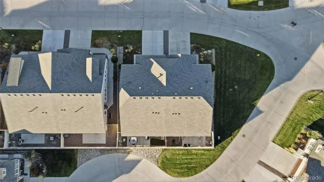 an aerial view of houses with a yard