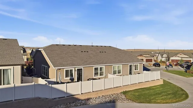 a view of a white house with a big yard and large tree