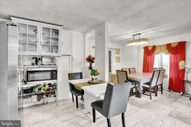 a view of a dining room with furniture and chandelier