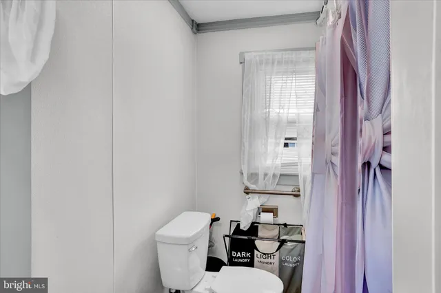 a white toilet sitting next to a bathroom sink