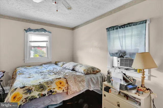 a bedroom with a bed and a lamp