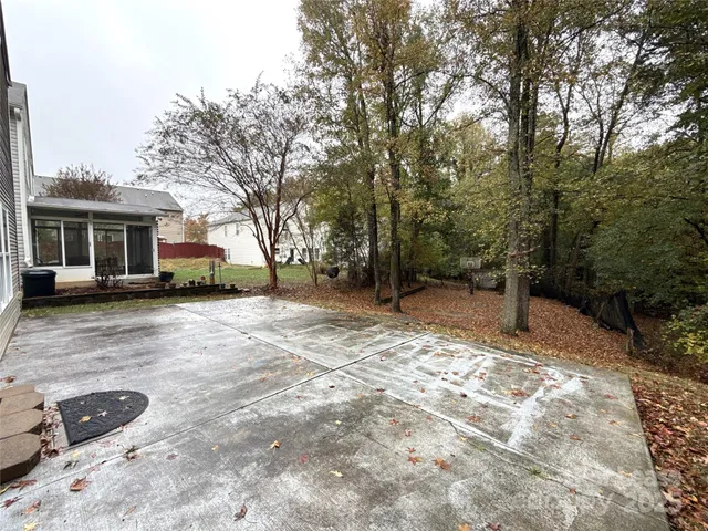 a view of a house with a yard covered in snow