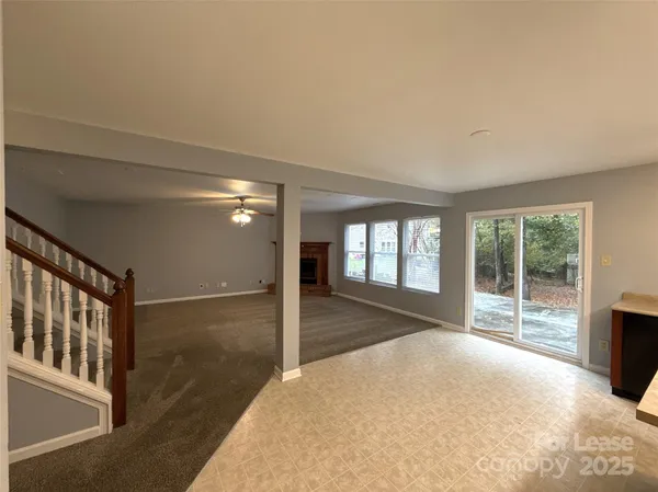 a view of hallway with windows and chandelier