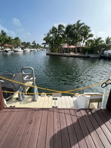 a view of a house with a big yard and large trees