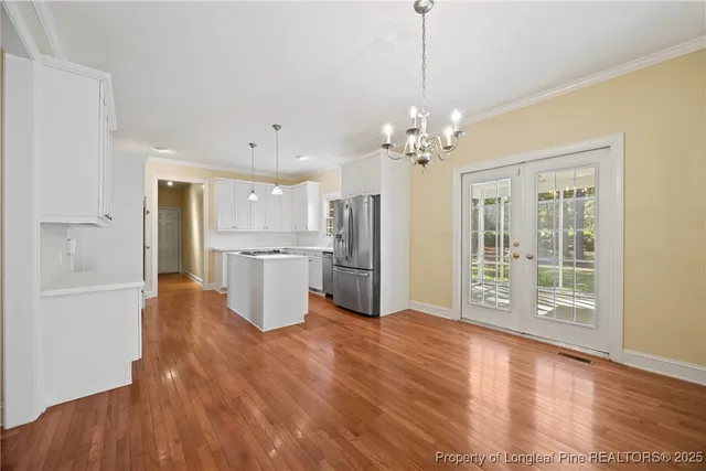 a bedroom with a bed and a lamp on the dresser