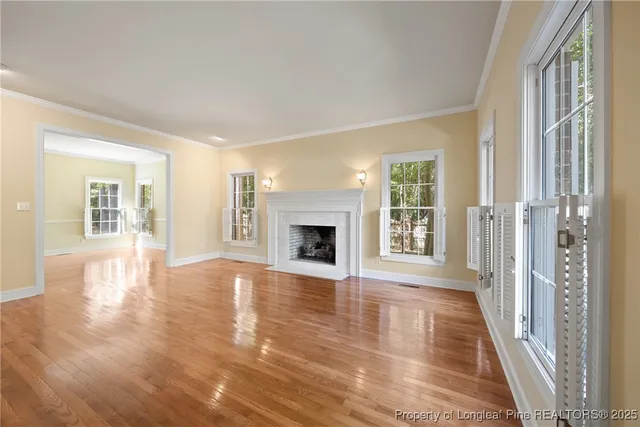 a view of a big room with wooden floor and a kitchen