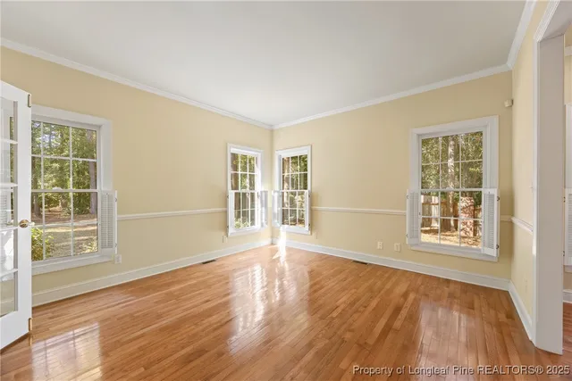 a kitchen with stainless steel appliances a refrigerator a sink dishwasher and wooden cabinets with wooden floor