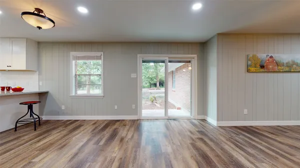 a view of room with hardwood floor and a window