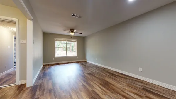 a view of an empty room and glass door