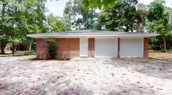 a wooden house with tree in front of it