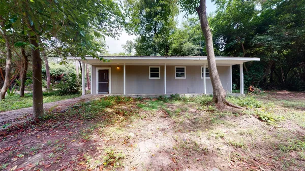 a view of a house with yard and a garden