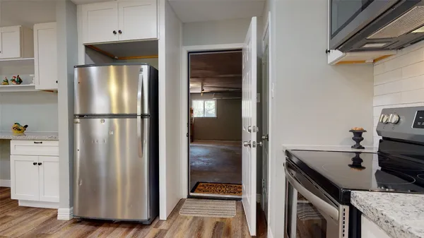 a kitchen with a refrigerator and a stove
