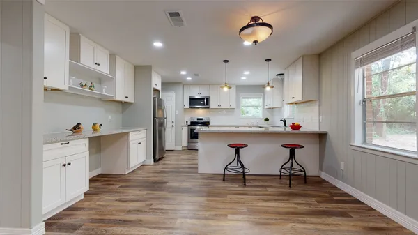 a view of kitchen with wooden floor and window
