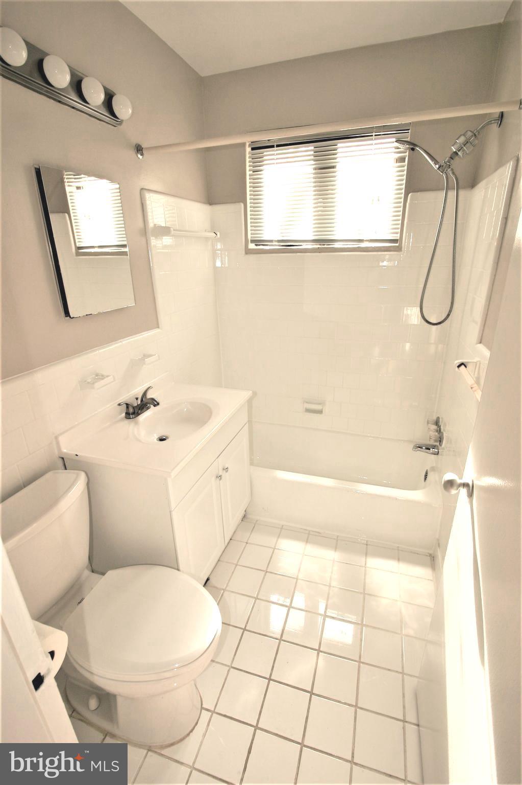 4114 Davis Place Northwest, Unit 210 Washington, DC 20007 - Photo 14 of 19 a bathroom with a sink toilet and shower
