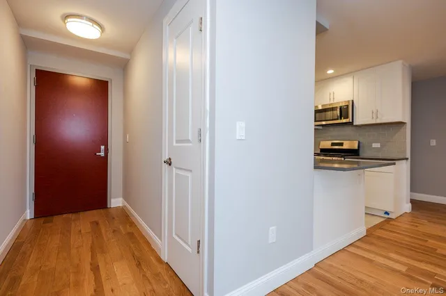a view of kitchen with sink and refrigerator