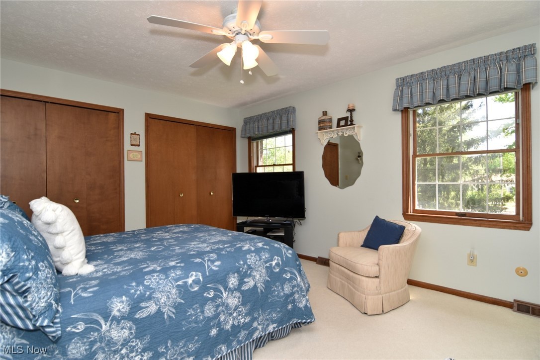 5510 Som Center Road Solon, OH 44139 - Photo 20 of 38 Carpeted bedroom with multiple closets, baseboards, and a ceiling fan