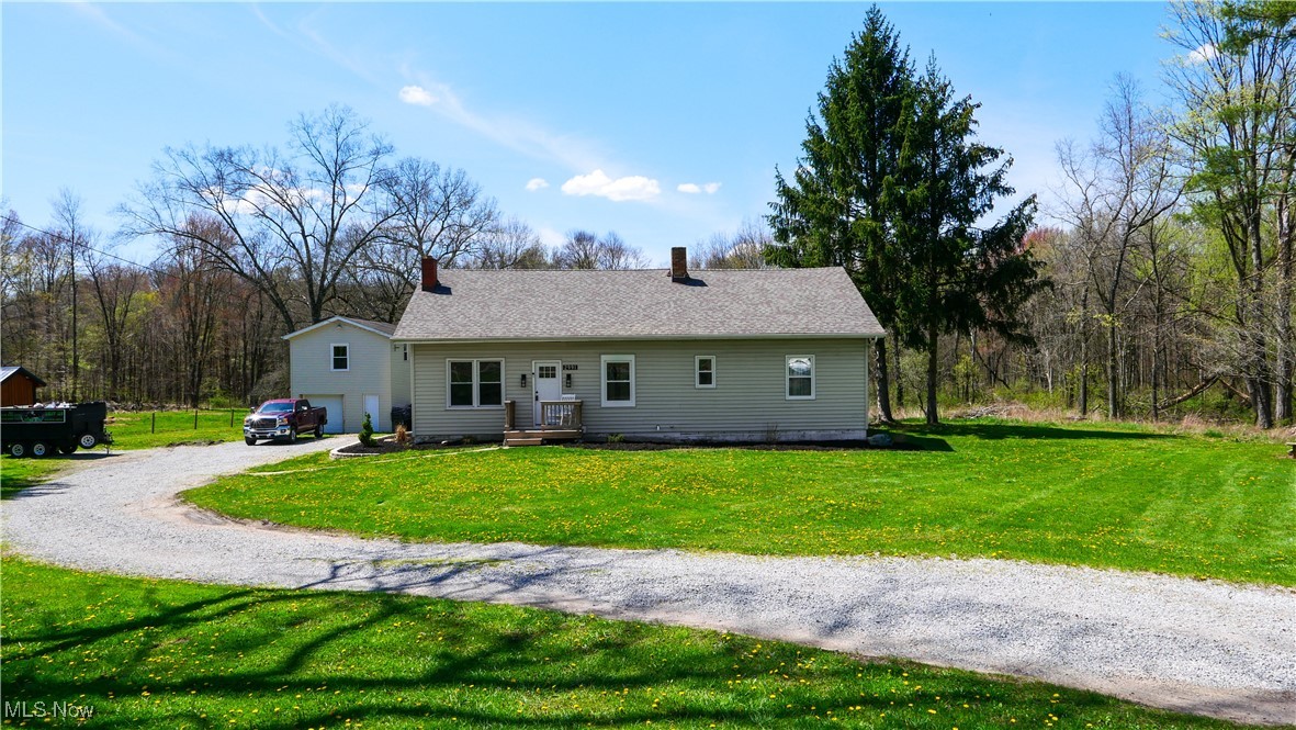 2991 Bushnell Campbell Road Fowler, OH 44418 - Photo 1 of 41 View of front of home with a chimney, gravel driveway, and a front lawn