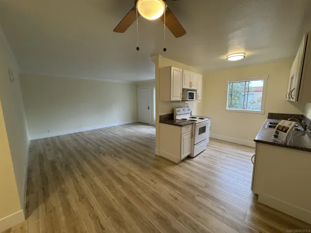a kitchen with granite countertop a stove and a sink