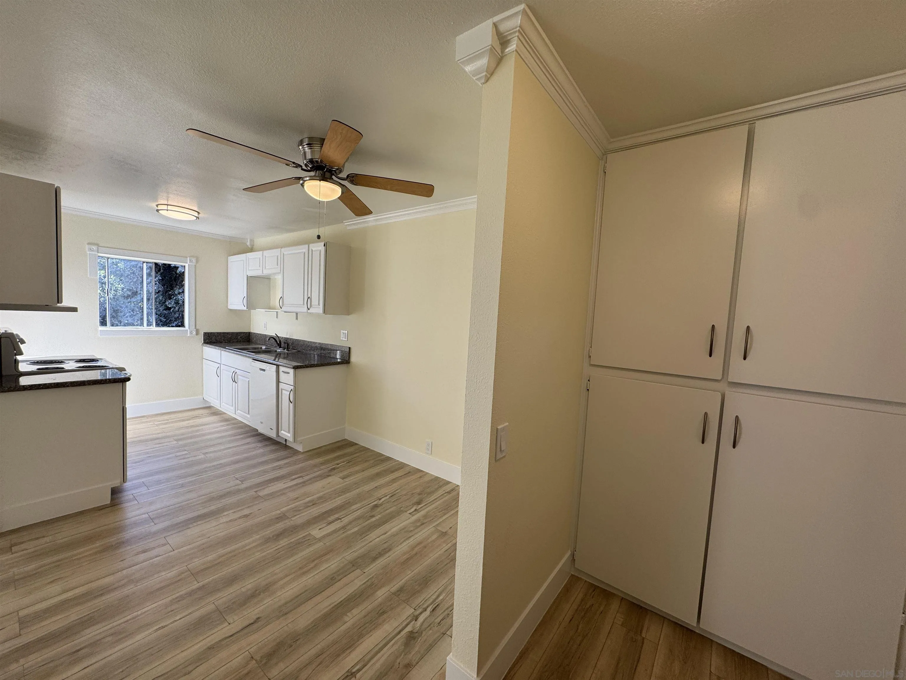 12923 Mapleview Street, Unit 8 Lakeside, CA 92040 - Photo 11 of 25 a view of kitchen with wooden floor electronic appliances and window